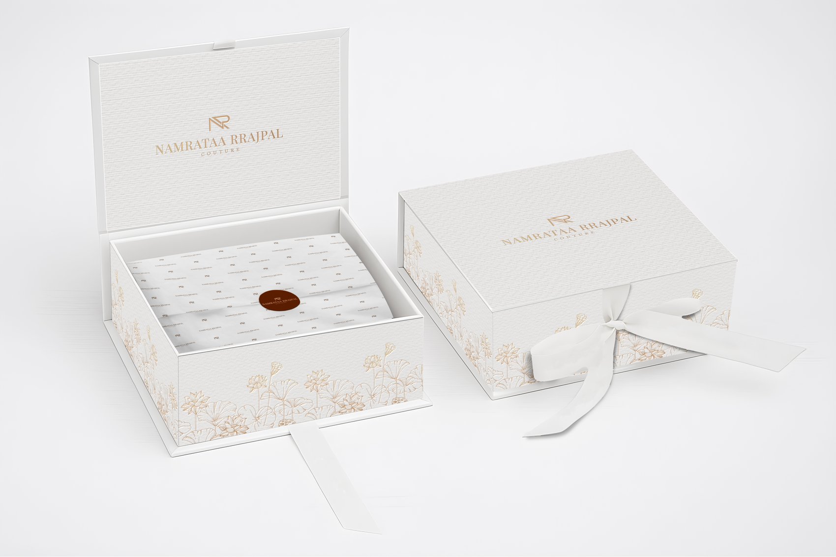 Namrataa Rrajpal Couture gift box with a ribbon tie and gold lotus foil pattern, shown open and closed